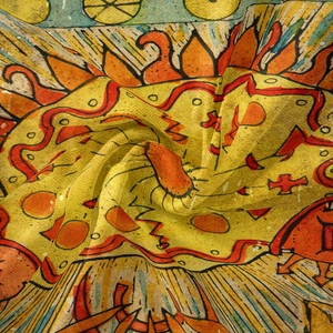 Detail of bohemian sun pattern tapestry fabric with soft texture and vibrant colors