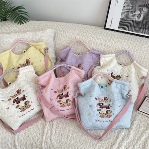 Detailed display of colorful quilted tote bags with cute cartoon embroidery and adjustable straps