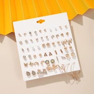 Detail of 20 pairs gold earring set with pearls and crystals on white display card