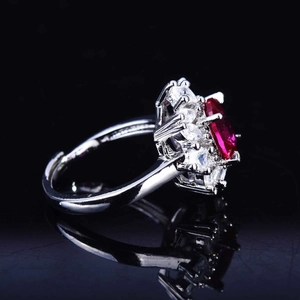 Macro view of luxurious red gemstone ring with surrounding diamonds and silver band