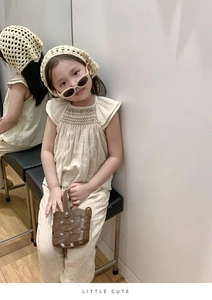 Detail view of retro woven crossbody bag paired with a stylish girls linen outfit set