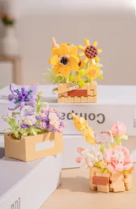 Macro view of assorted building block flower bonsai with roses and sunflowers on white decor