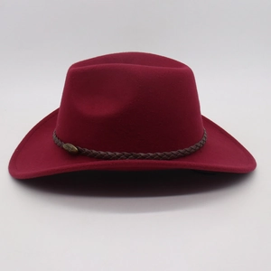 Close-up of wine red felt cowboy hat with vintage bronze buckle on leather band