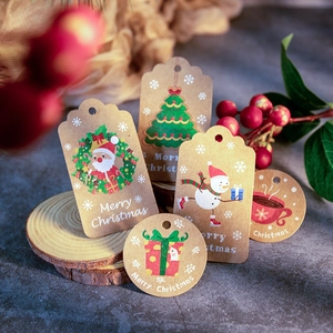Close-up of brown kraft paper Christmas gift tags with hemp ropes and festive motifs