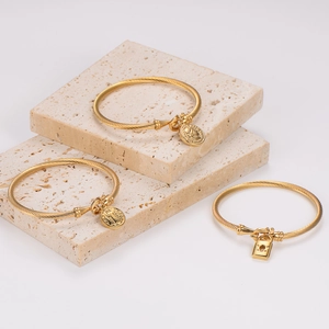 Three-piece gold stainless steel cable cuff bracelet set with coin and heart lock charms