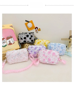 Detail of floral lace crossbody bags for girls in various pastel colors with embroidery