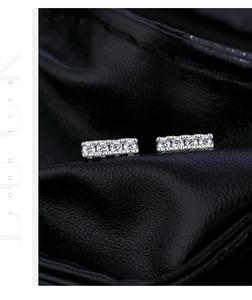 Gros plan de boucles d'oreilles en argent 925 avec cinq pierres de moissanite étincelantes