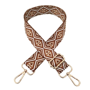 Detail of geometric diamond pattern strap with polished gold-tone metal lobster clasps