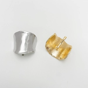 Detail of silver smooth and gold brushed irregular metal hair hooks with needle clasps