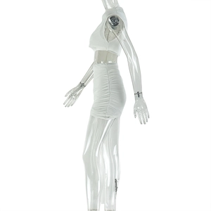 Detail of white two-piece set featuring ruched skirt side seams and sleeveless crop top