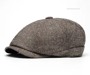 Detail of khaki wool tweed flat cap featuring thick texture and a decorative top button