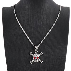 Detailed macro view of hip-hop skull pendant with red rhinestone eyes on a silver chain