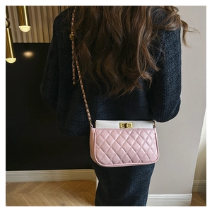 Close-up of pink and white quilted PU leather crossbody bag with gold chain strap