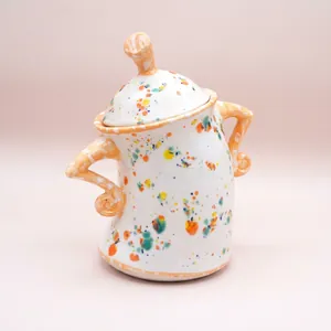Artistic ceramic storage jar with colorful splash pattern and playful pose handles