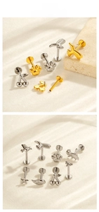 Macro detail of G23 titanium piercing jewelry featuring animal and celestial shapes