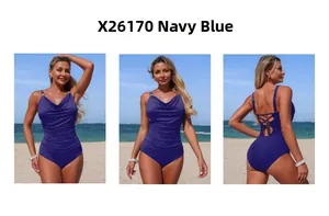Detail view of navy blue one-piece swimsuit with halter V-neck and ruched belly design