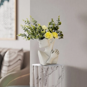 Modern white ceramic portrait vase with hand-carved female profile and elegant floral display