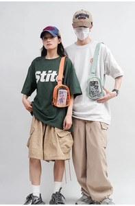 Detail of candy-colored PVC crossbody bags in orange and mint green on models
