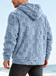 Outdoor back view of men's blue fleece hoodie with embossed check and plush texture