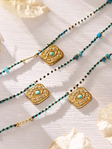 Macro detail of Evil Eye pendant with colorful turquoise beads on a rustic wood background
