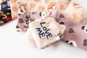 Detail of cotton crew socks with animal faces, heart patterns and LOVE ME text