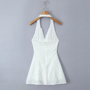 Detail of white hollow embroidery on a halter backless dress made of premium cotton fabric