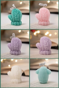 Detail showing colorful knitted glove shaped scented candles for Christmas decoration