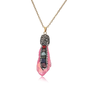 Detail of pink crystal pendant with multi-color rhinestones and gold chain necklace