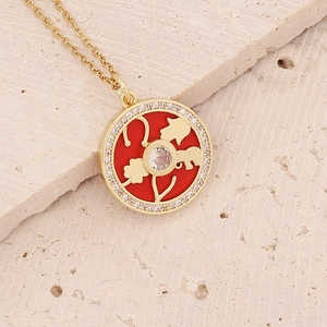Gold-plated necklace with Hamsa and clover symbols on a red enamel pendant