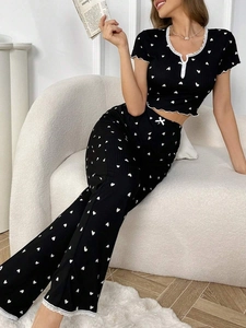 Detail of lace trim on black heart print pajamas set with ribbed fabric texture