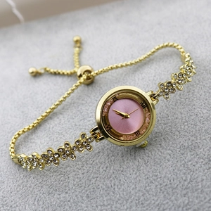 Elegant gold flower bracelet watch for women with pink glitter dial and rhinestone accents