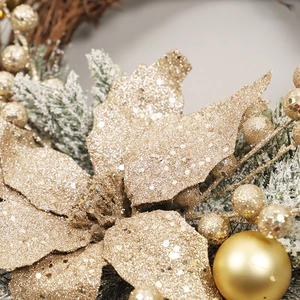 Golden Christmas wreath with pine needles, poinsettia flower and ornaments for front door