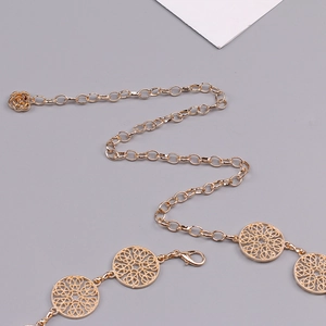 Detail of gold hollow circle metal chain belt featuring intricate floral patterns and lobster clasp
