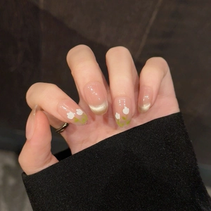 Close-up of almond-shaped press-on nails with hand-painted tulips and cat-eye finish