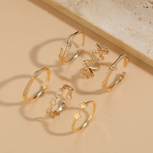 6-piece gold ring set featuring feather, bamboo texture, and heart designs for women
