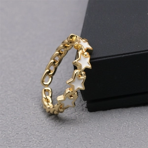 Detail view of 18K gold star ring with white enamel accents and chain-style band