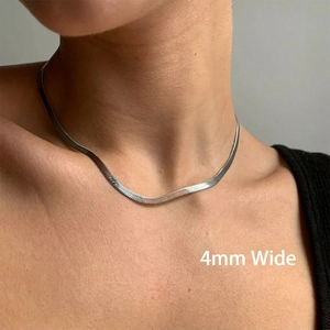 Close-up of a 4mm silver flat snake chain necklace on neck with polished steel finish