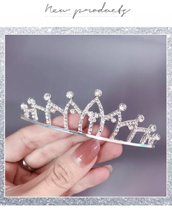 Detailed macro view of small silver tiara comb with sparkling white rhinestones and crystals