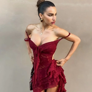 Detail of red lace off-shoulder dress featuring a V-neck and tiered ruffle hemline