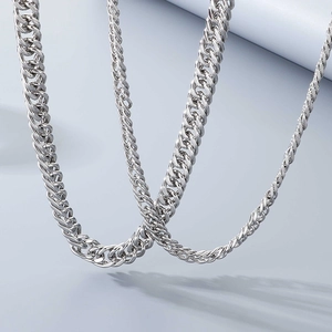 Macro view showing the polished curb chain details and metallic texture of the link necklace