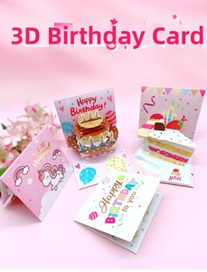 Close-up of 3D pop-up birthday cards with cake and unicorn designs on pink background