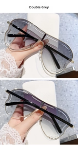 Détail de lunettes de soleil oversize rétro avec des verres dégradés gris double