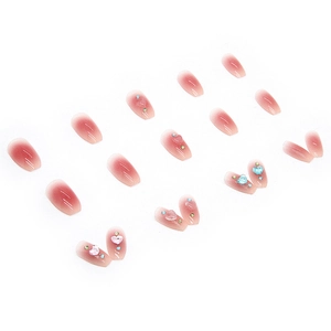 Light-sensitive color-changing heart press-on nails with pink gradient and rhinestones
