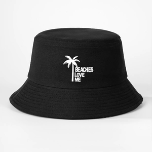 Detail of black cotton bucket hat showing beaches love me text and palm tree embroidery