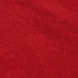 Detailed macro view of high-quality red floral lace fabric with intricate patterns