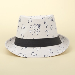 Detail of floral print straw sun hat with black ribbon band on a neutral background