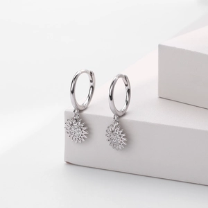 Macro view of S925 sterling silver sunflower earrings with clear cubic zirconia pavé