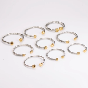 Set of nine stainless steel cable wire open bangles in two-tone silver and gold finishes