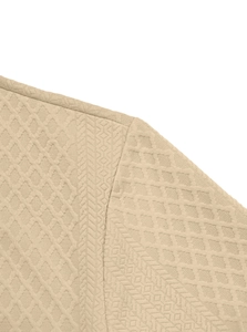 Macro shot of textured knit fabric with diamond pattern on men's long sleeve polo