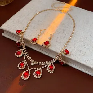 Luxury gold-plated necklace and earring set with red teardrop stones and tassels